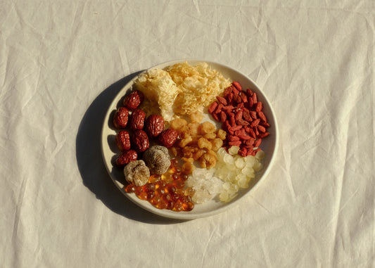 Chinese herbal dessert blend tong sui on a plate with snow fungus, goji berries, dried longan, snow swallow, snow lotus seed, peach gum, honey date and red dates jujube. Image 1