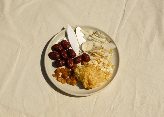 Chinese herbal soup mix blend on a plate with Chinese herbs  Chinese yam huai Shan, red dates jujube, longan, snow fungus, American ginseng xi yang shen, coconut. Image 1