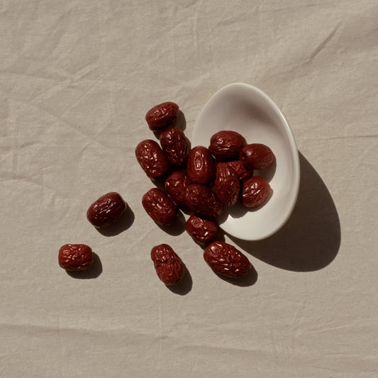 Red dates jujube tipped out of a bowl. Image 1