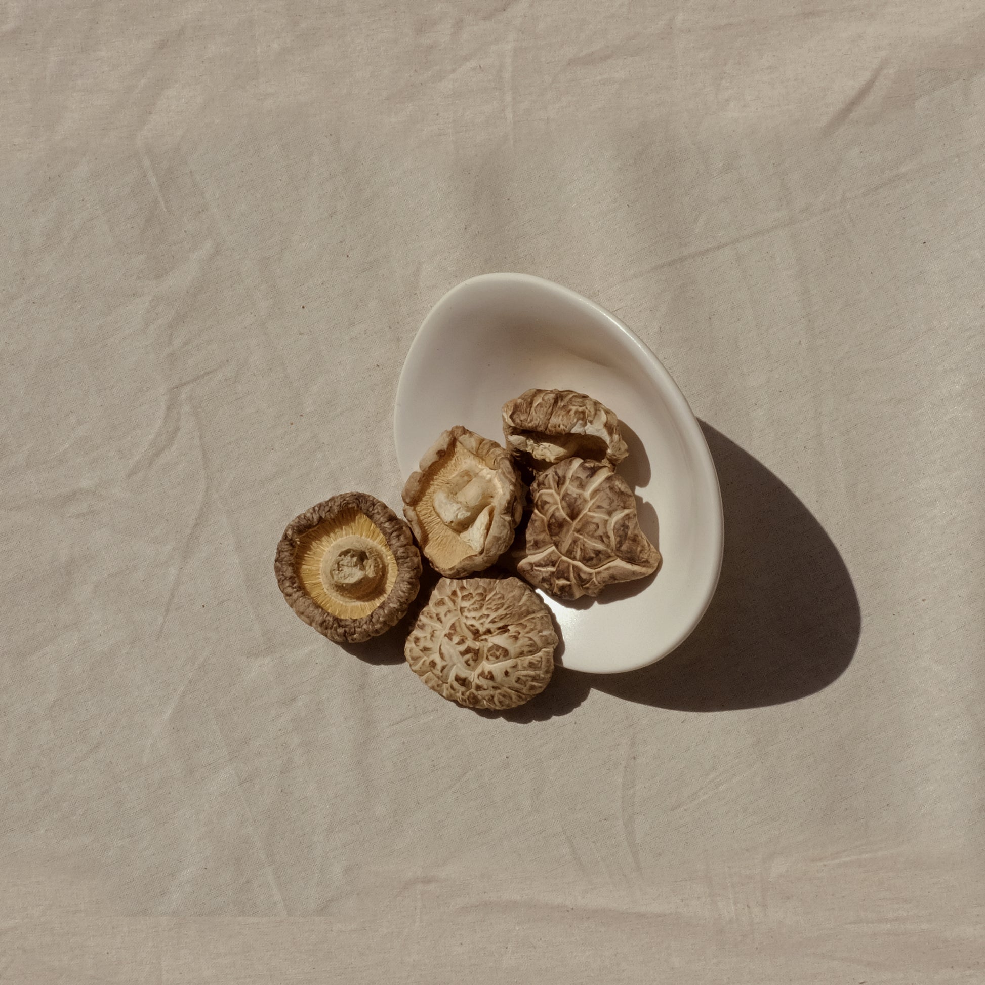 Shiitake mushrooms tipped out of a bowl. Image 1